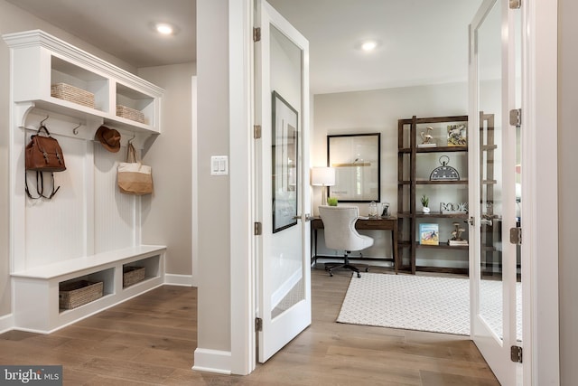 mudroom with recessed lighting, french doors, baseboards, and wood finished floors