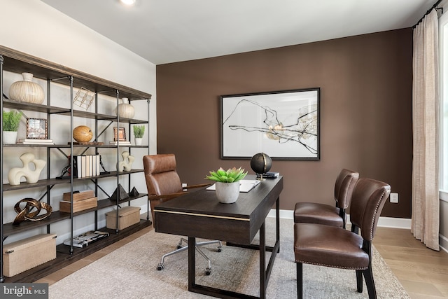 home office featuring wood finished floors and baseboards