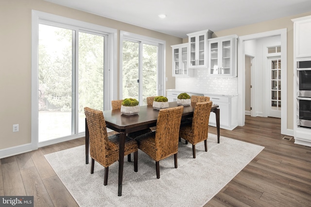 dining space featuring recessed lighting, baseboards, and wood finished floors