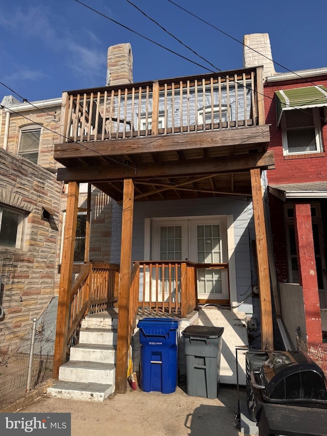 view of home's exterior with a porch and a chimney