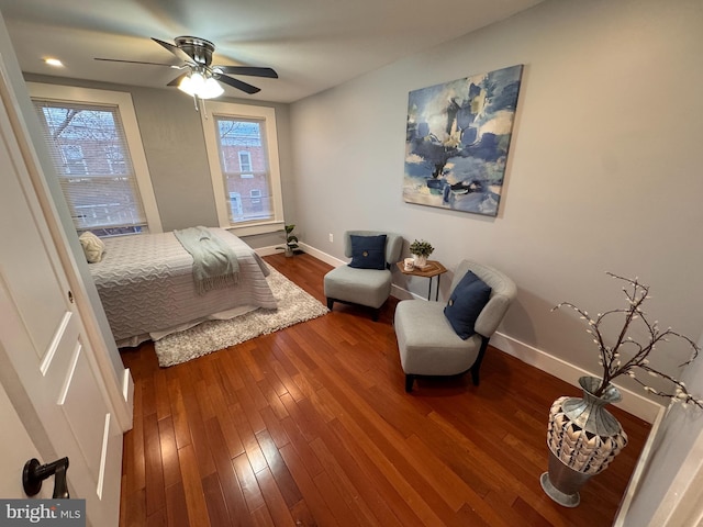 bedroom featuring a ceiling fan, wood finished floors, and baseboards