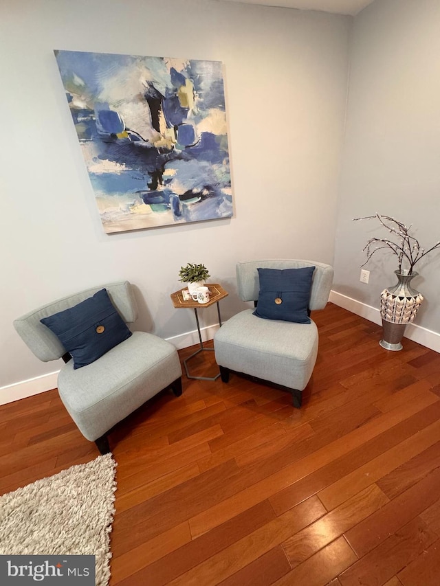 living area featuring wood finished floors and baseboards