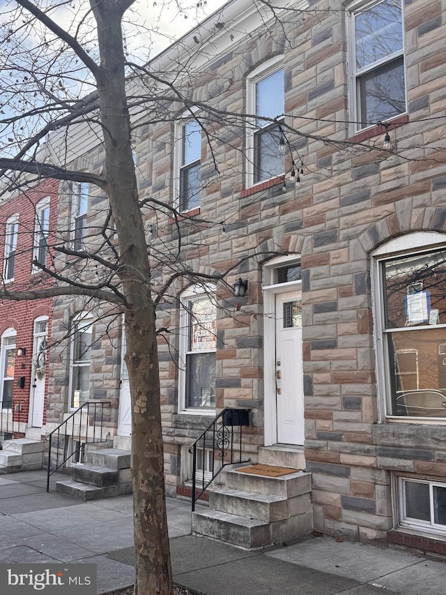 property entrance featuring stone siding