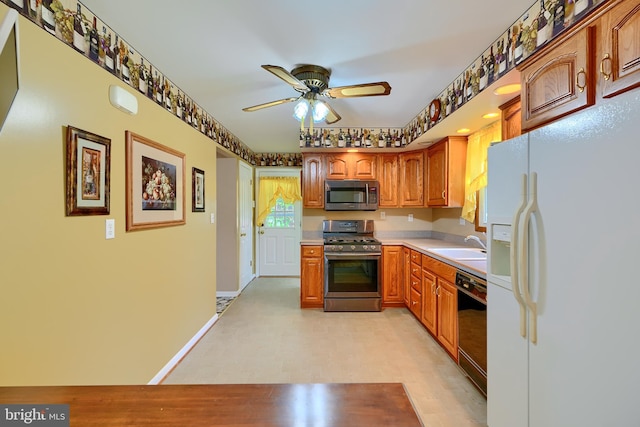 kitchen with ceiling fan, a sink, light countertops, stainless steel appliances, and brown cabinets