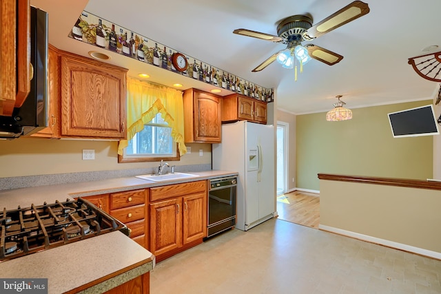 kitchen featuring brown cabinetry, crown molding, black dishwasher, and a sink