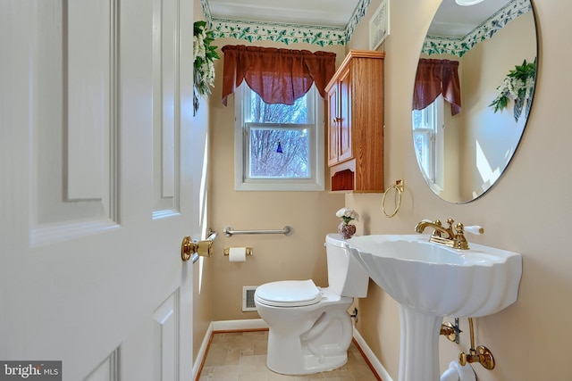 bathroom featuring toilet, baseboards, and visible vents