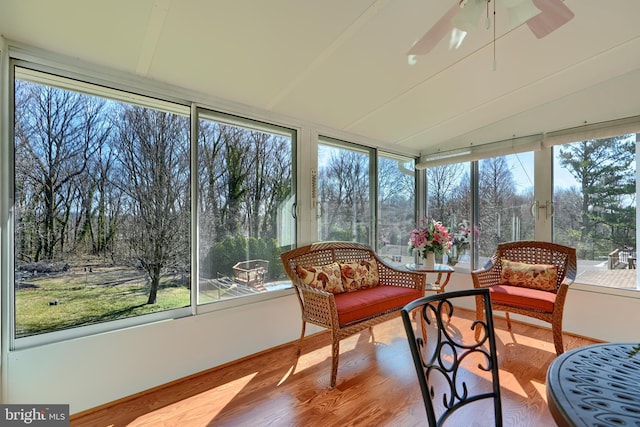 sunroom / solarium featuring ceiling fan and vaulted ceiling