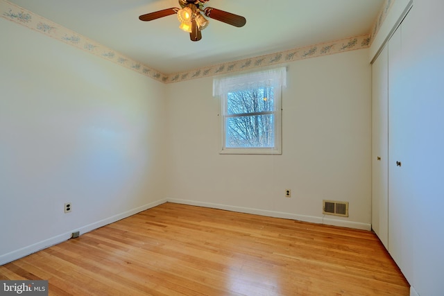 unfurnished bedroom featuring visible vents, baseboards, a closet, and light wood finished floors