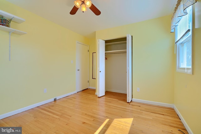 unfurnished bedroom featuring ceiling fan, light wood-type flooring, and baseboards