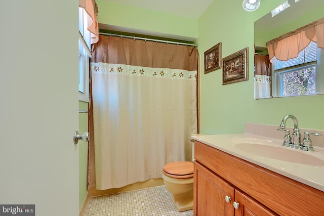 full bathroom with tile patterned flooring, curtained shower, toilet, and vanity