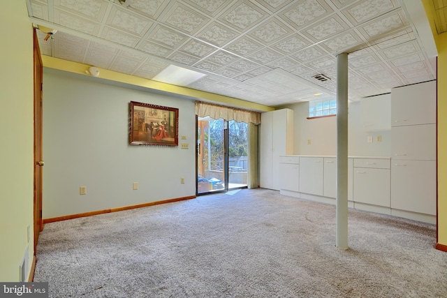 interior space with visible vents, baseboards, an ornate ceiling, and carpet floors