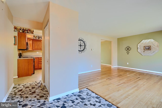 interior space featuring light wood-style flooring and baseboards