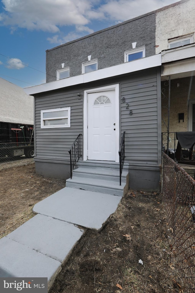 doorway to property with fence