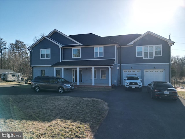 view of front of property featuring aphalt driveway, a porch, and an attached garage