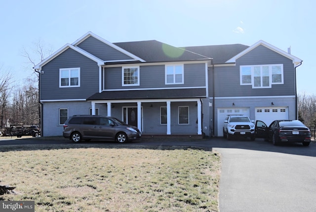 view of front of house with a porch, an attached garage, and driveway