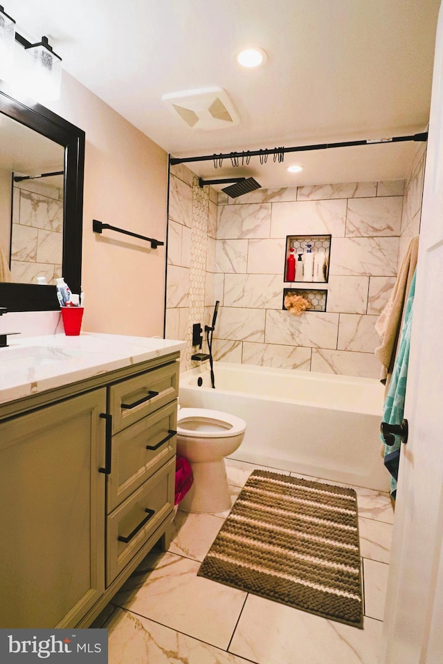 full bath featuring visible vents, toilet, bathtub / shower combination, marble finish floor, and vanity