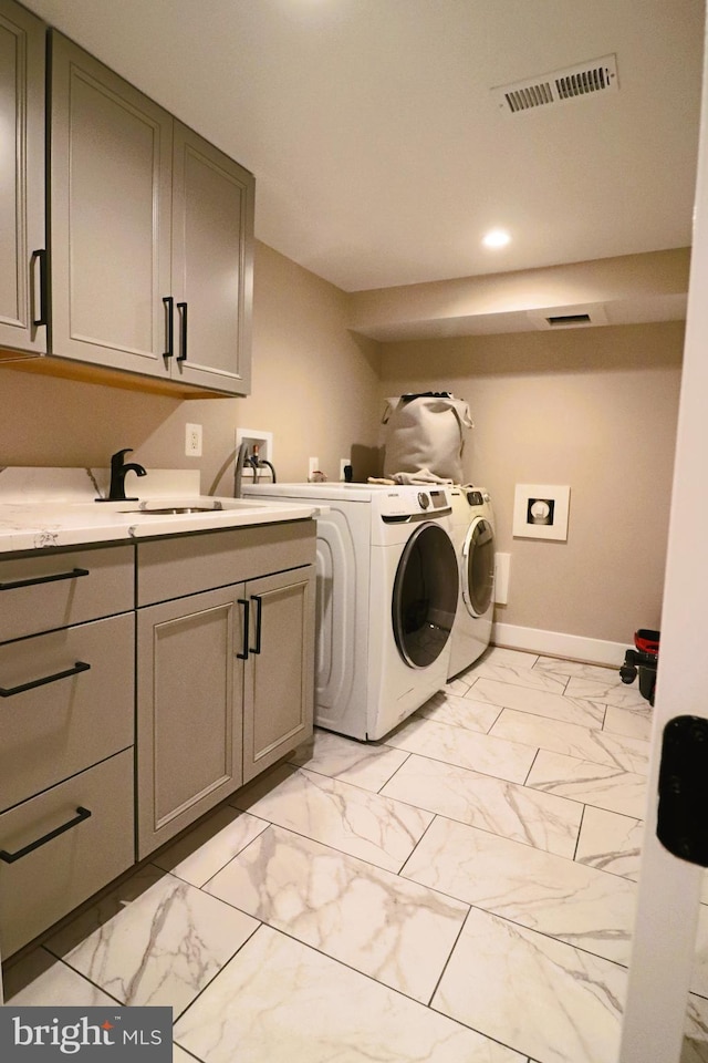 washroom featuring a sink, visible vents, cabinet space, and marble finish floor