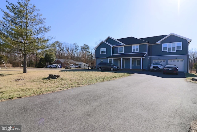 view of front of house with aphalt driveway and an attached garage