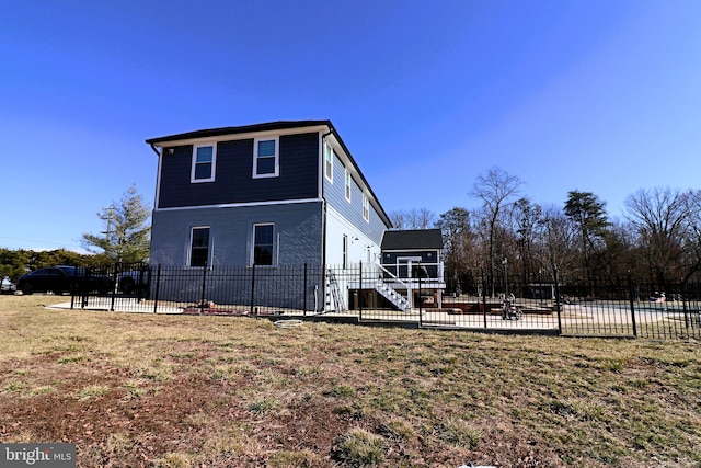 view of side of property featuring a patio, stairs, and fence