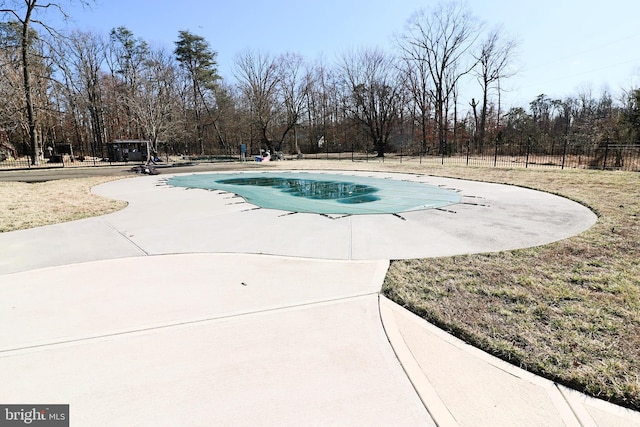 community pool featuring a patio area and fence