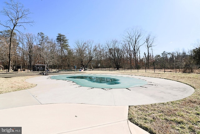 community pool featuring a patio and fence