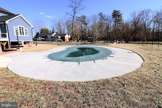 view of swimming pool with a patio area, a fenced in pool, a yard, and fence