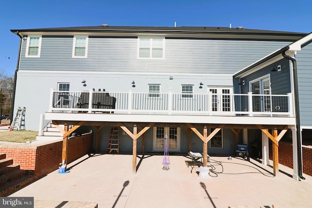 back of house with a patio, french doors, and a wooden deck