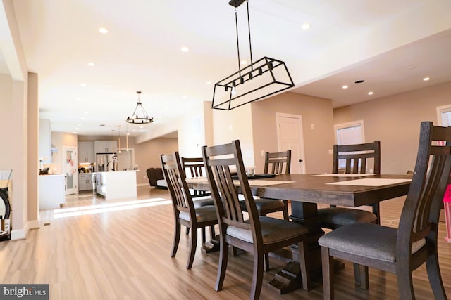 dining area with recessed lighting, light wood-type flooring, and baseboards