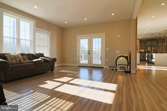 living room featuring recessed lighting, french doors, and wood finished floors