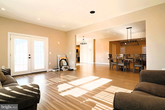 living room featuring recessed lighting, wood finished floors, and baseboards