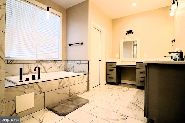 bathroom with vanity, a bath, a healthy amount of sunlight, and marble finish floor