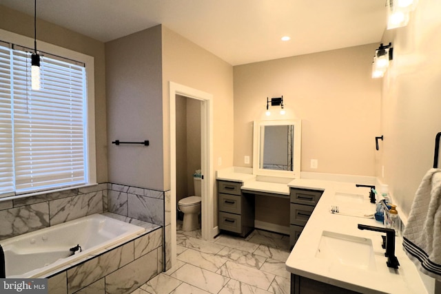 full bathroom featuring double vanity, a bath, marble finish floor, and a sink