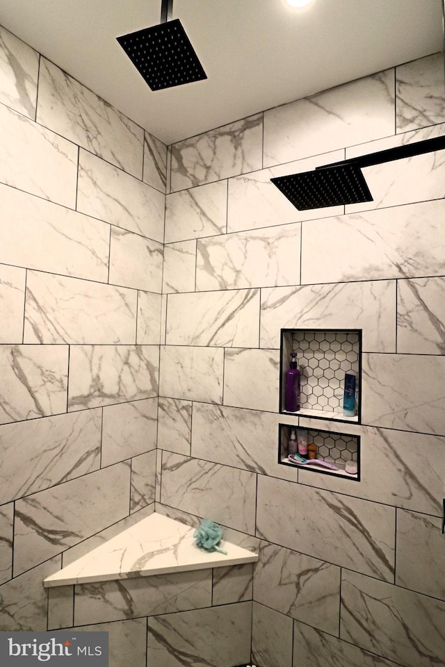 bathroom with a tile shower