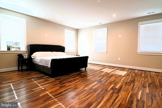 bedroom featuring visible vents, recessed lighting, baseboards, and wood finished floors