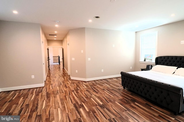 bedroom with recessed lighting, baseboards, and wood finished floors