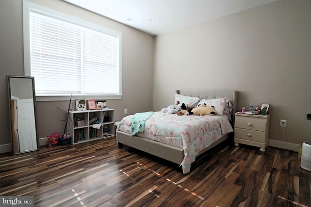 bedroom featuring dark wood-style flooring