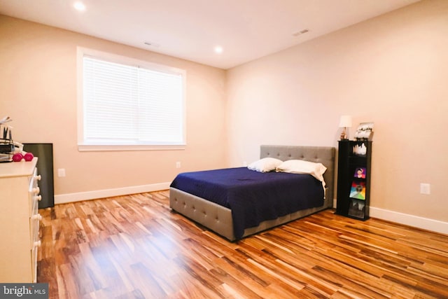 bedroom featuring recessed lighting, baseboards, and light wood-style floors