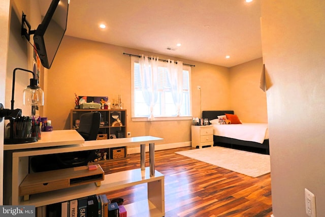 bedroom with recessed lighting, baseboards, and wood finished floors