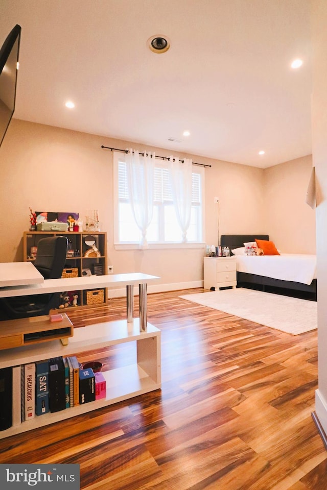 bedroom featuring recessed lighting and wood finished floors