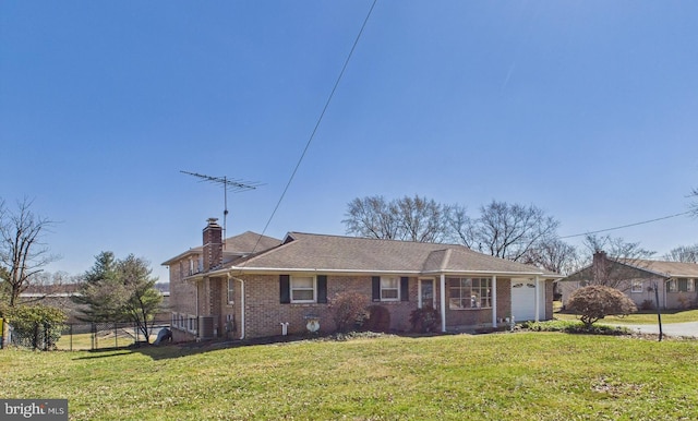 view of front of house with fence, a chimney, a front lawn, a garage, and brick siding