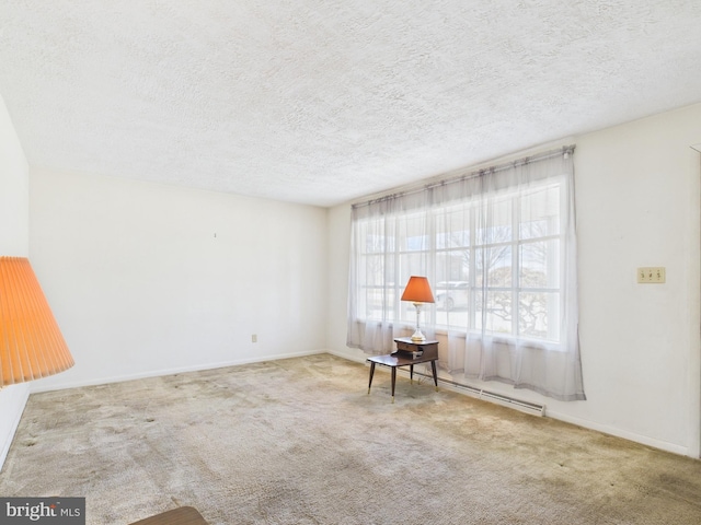 unfurnished room with a baseboard heating unit, carpet, baseboards, and a textured ceiling