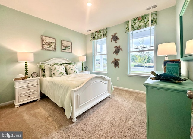 carpeted bedroom featuring visible vents and baseboards