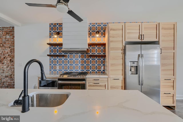 kitchen with a sink, light brown cabinets, tasteful backsplash, and stainless steel appliances