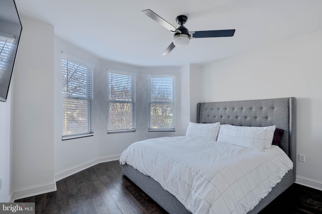 bedroom with dark wood-style floors, baseboards, and ceiling fan