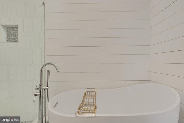 full bathroom featuring a soaking tub