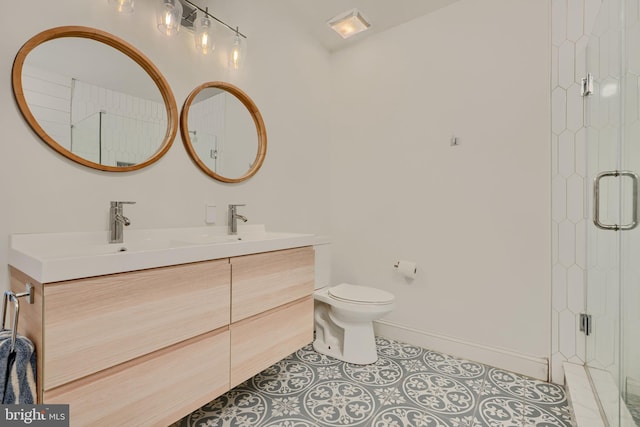 bathroom with toilet, a shower stall, tile patterned flooring, double vanity, and baseboards