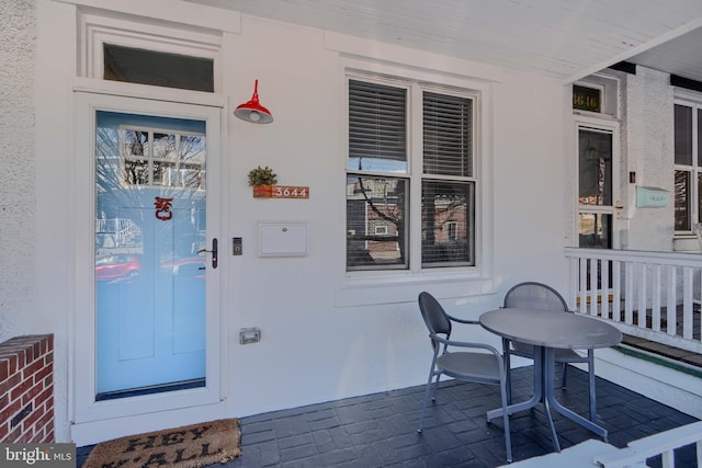 doorway to property featuring stucco siding