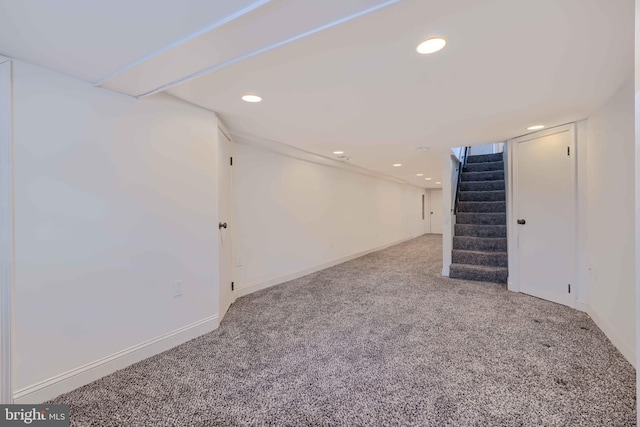 finished basement featuring recessed lighting, stairs, baseboards, and carpet floors