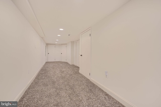 carpeted spare room featuring recessed lighting and baseboards