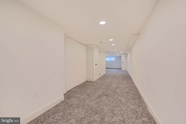 hallway with recessed lighting, baseboards, and light carpet